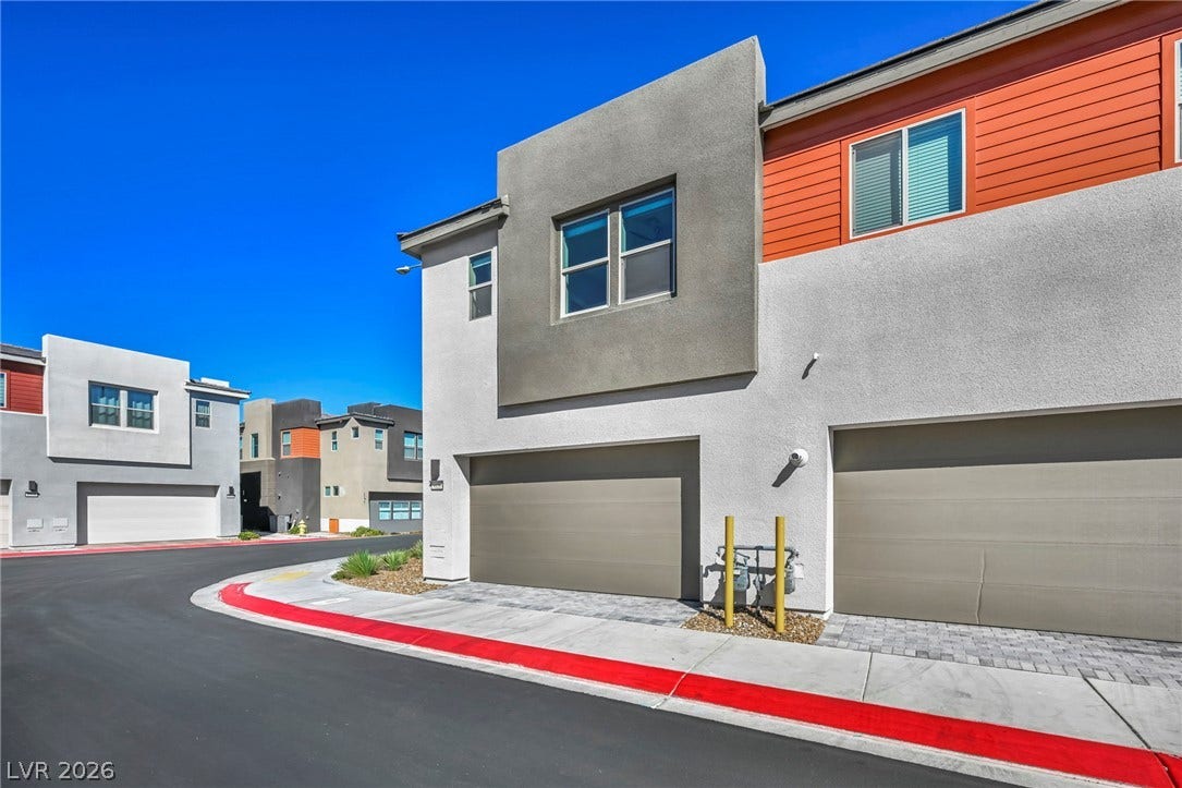 9826 Canyon Sage Street, Las Vegas, NV 89141 Modern multi-level exterior architecture features clean lines, stucco siding, and integrated multi-car garage bays.