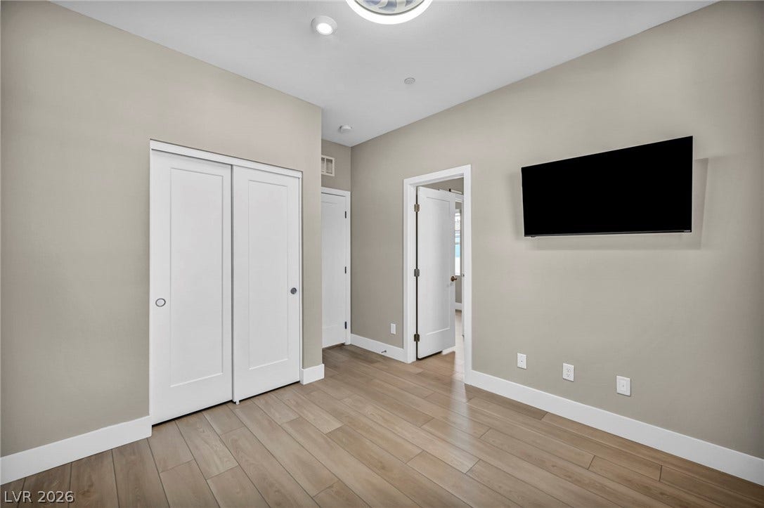 9826 Canyon Sage Street, Las Vegas, NV 89141 Smooth wood-look flooring and crisp trim highlight this modern interior space.