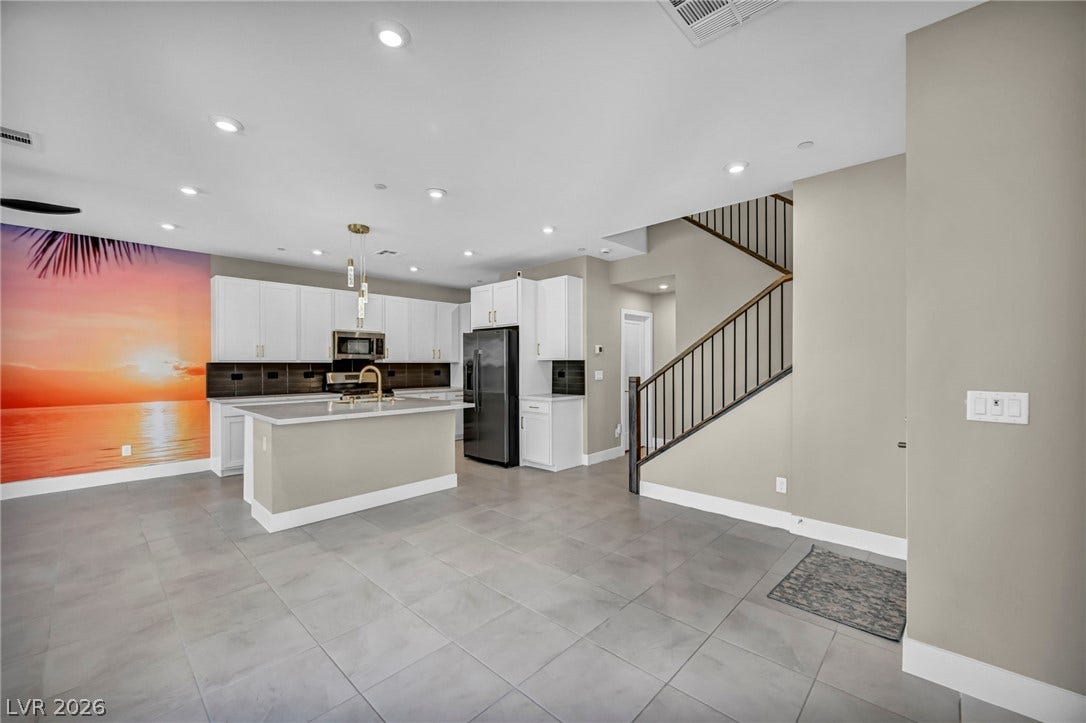 9826 Canyon Sage Street, Las Vegas, NV 89141 An open floorplan seamlessly connects the modern kitchen with the adjacent living and transition spaces.