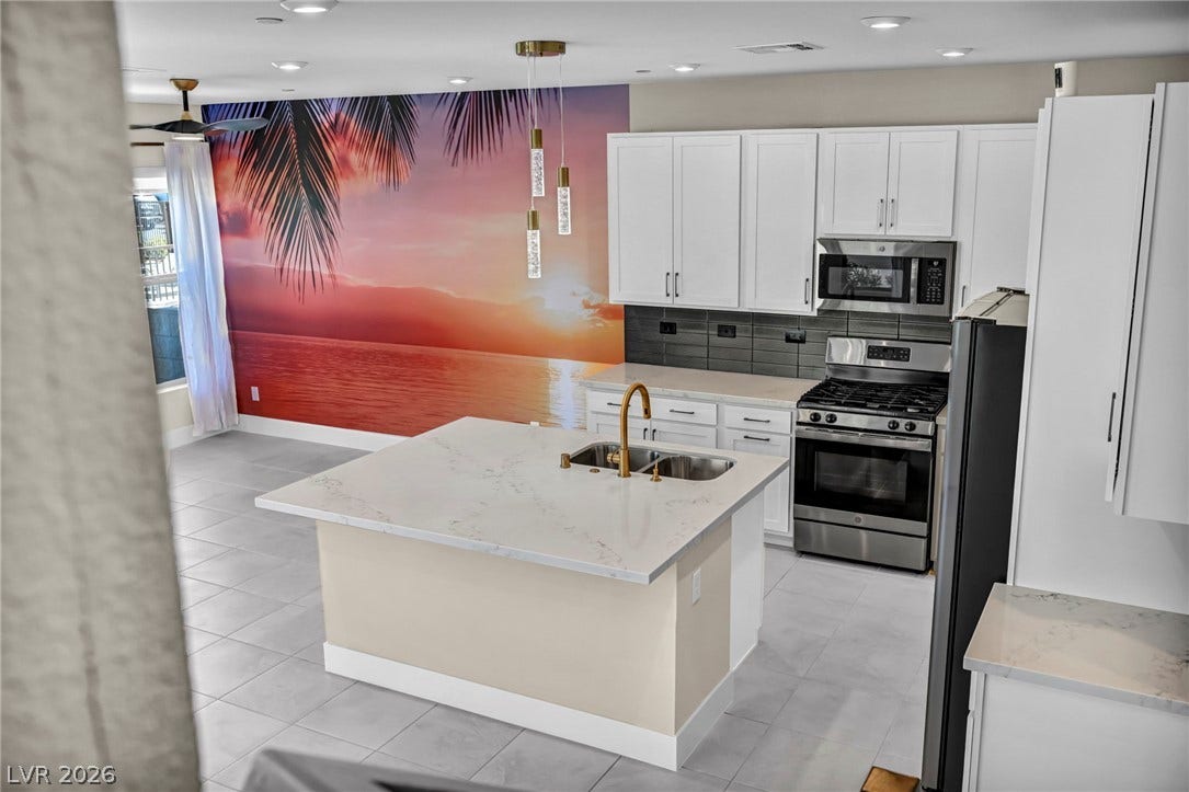 9826 Canyon Sage Street, Las Vegas, NV 89141 An open kitchen layout features a central island and sleek solid surface countertops.