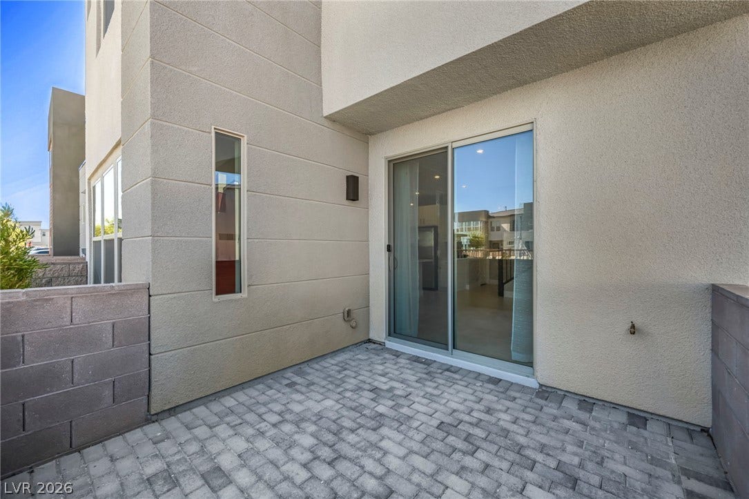 9826 Canyon Sage Street, Las Vegas, NV 89141 A private paved courtyard provides a quiet outdoor retreat directly off the main living space.