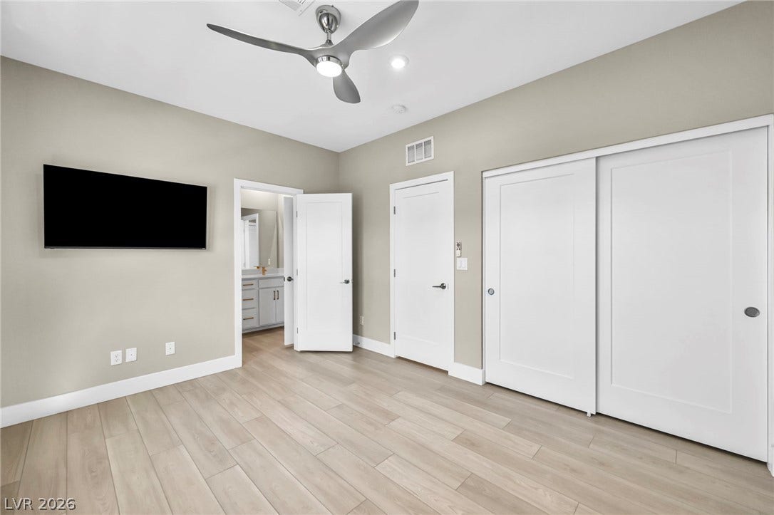 9826 Canyon Sage Street, Las Vegas, NV 89141 Smooth wood flooring and a clean design define this serene bedroom space.