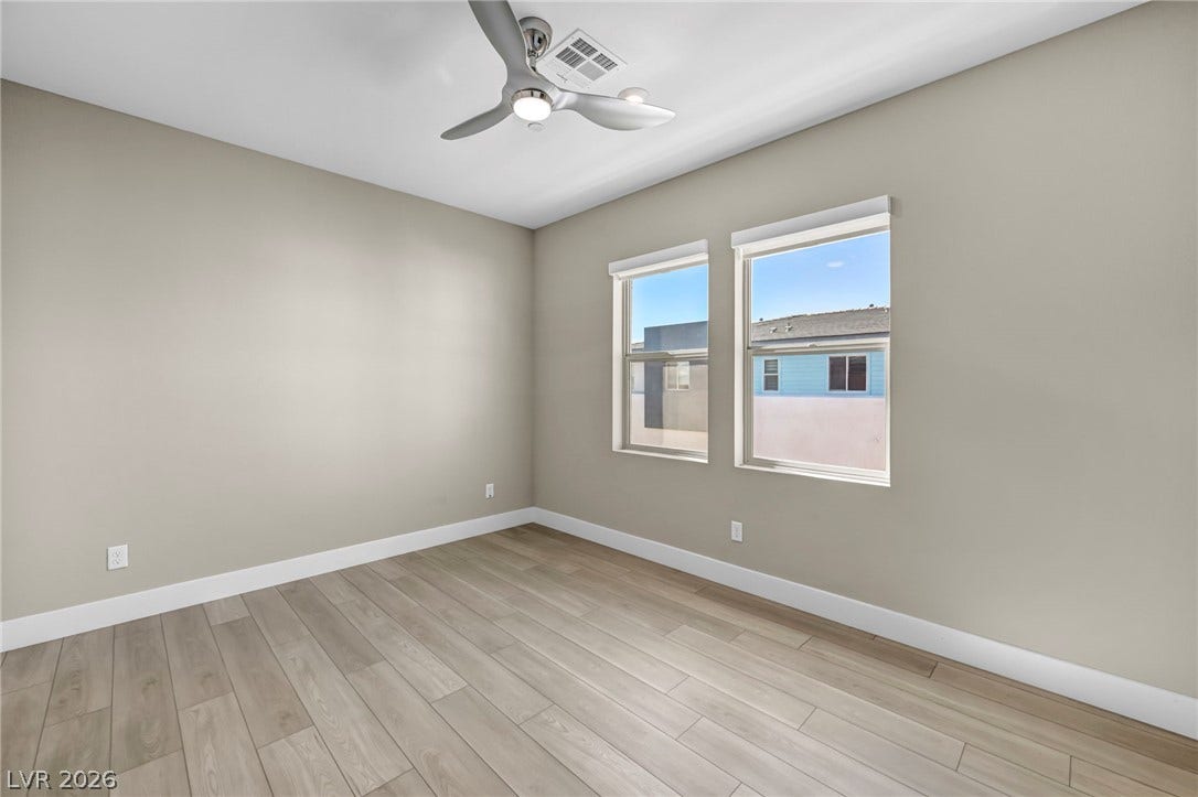 9826 Canyon Sage Street, Las Vegas, NV 89141 Gleaming wood-look floors anchor this versatile secondary bedroom highlighted by dual picture windows.