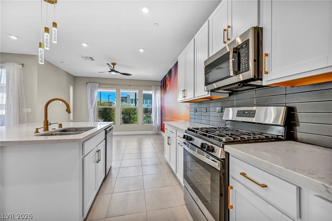 9826 Canyon Sage Street, Las Vegas, NV 89141 Tiled floors and modern cabinetry frame this contemporary kitchen space.