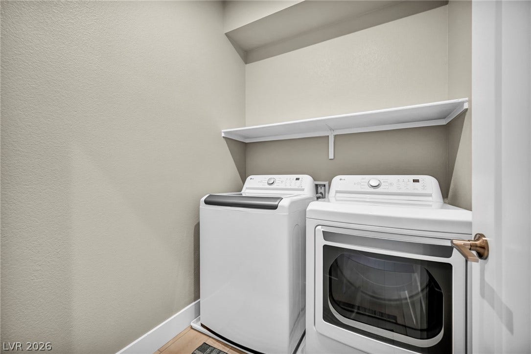 9826 Canyon Sage Street, Las Vegas, NV 89141 Functional utility space features overhead shelving above dedicated laundry connections.