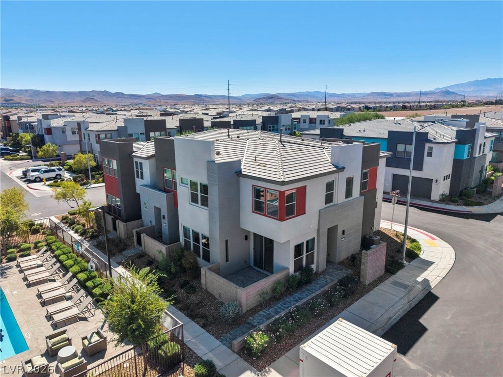9826 Canyon Sage Street, Las Vegas, NV 89141 Modern multi-level exterior architecture features clean lines against a desert mountain backdrop.