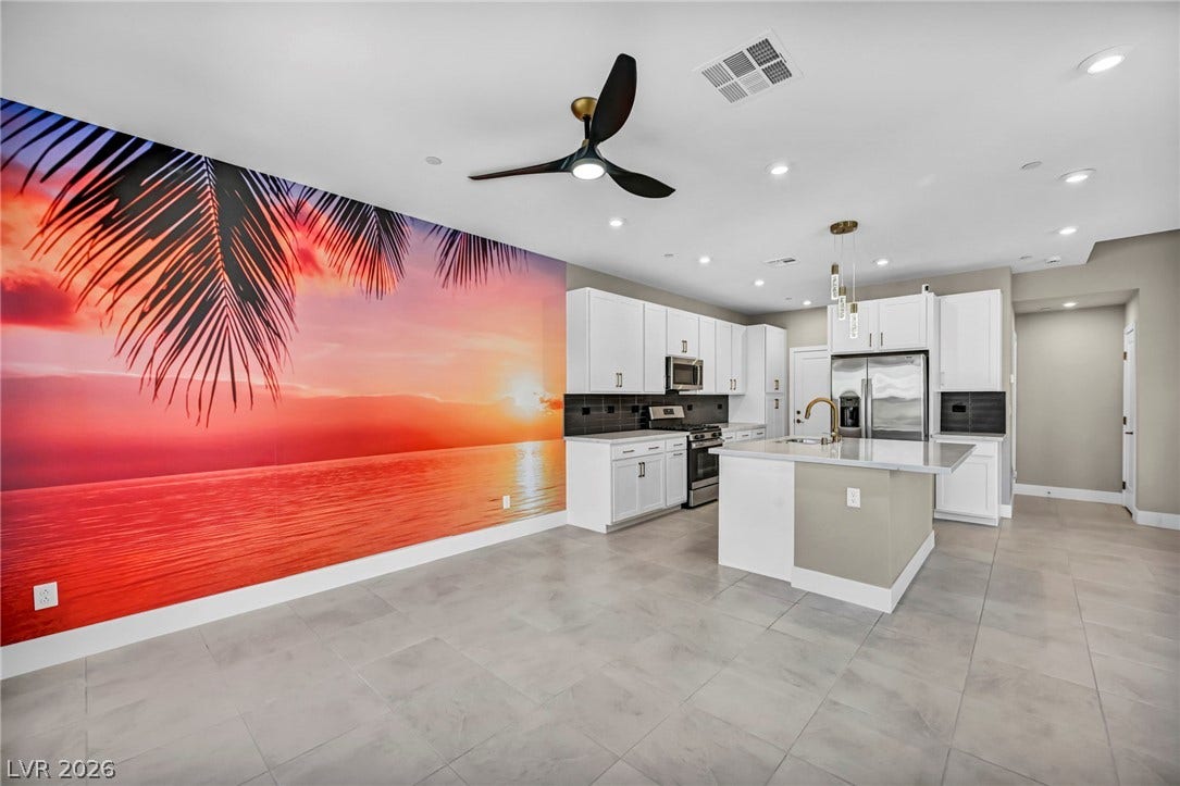 9826 Canyon Sage Street, Las Vegas, NV 89141 Gleaming tile floors and a central prep island anchor this contemporary cooking space.
