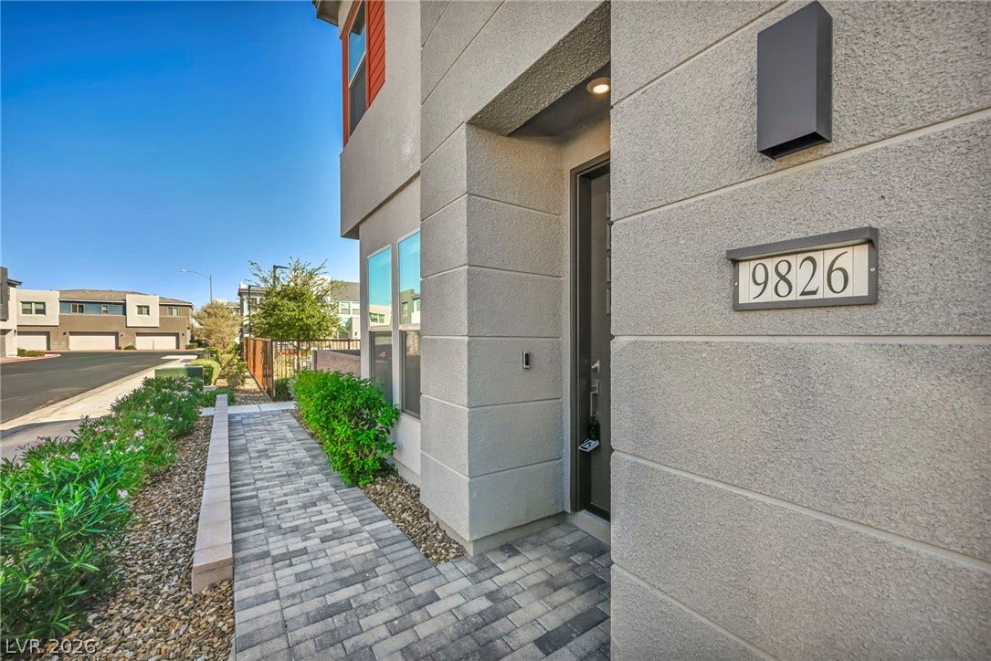 9826 Canyon Sage Street, Las Vegas, NV 89141 A neat stone paver path guides visitors to the recessed front entry.