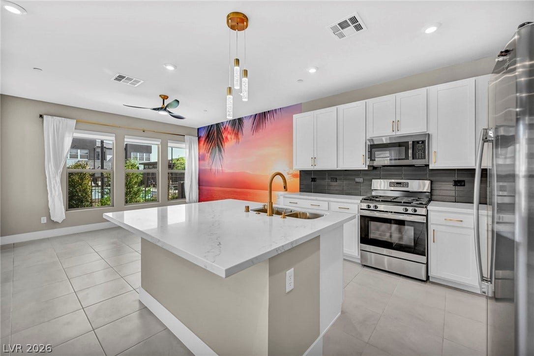 9826 Canyon Sage Street, Las Vegas, NV 89141 Sleek modern cabinetry and stone countertops anchor this bright open culinary space.