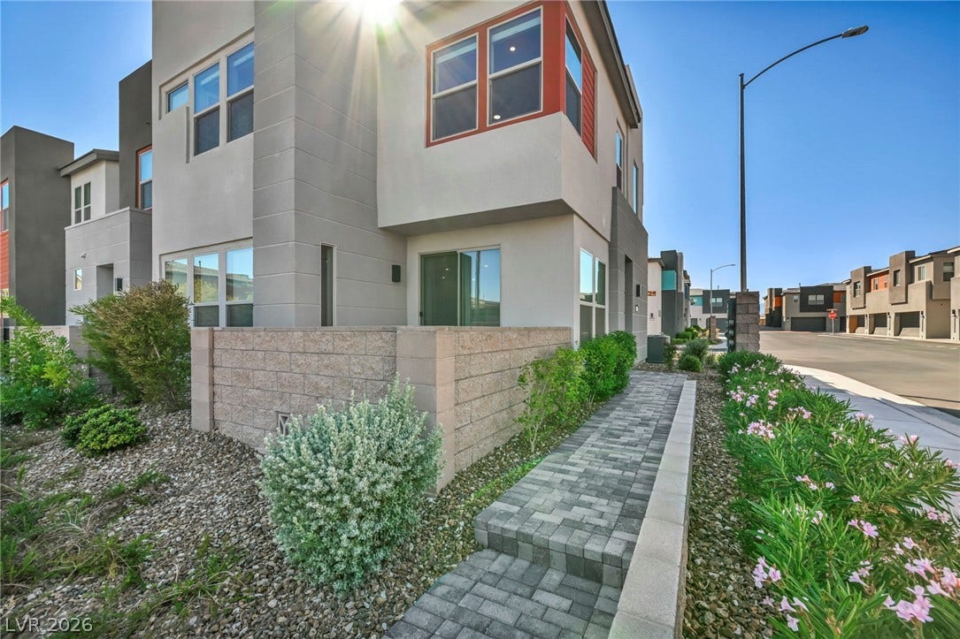 9826 Canyon Sage Street, Las Vegas, NV 89141 Modern multi-level exterior architecture features clean lines, structured stucco finishes, and a paved walkway.
