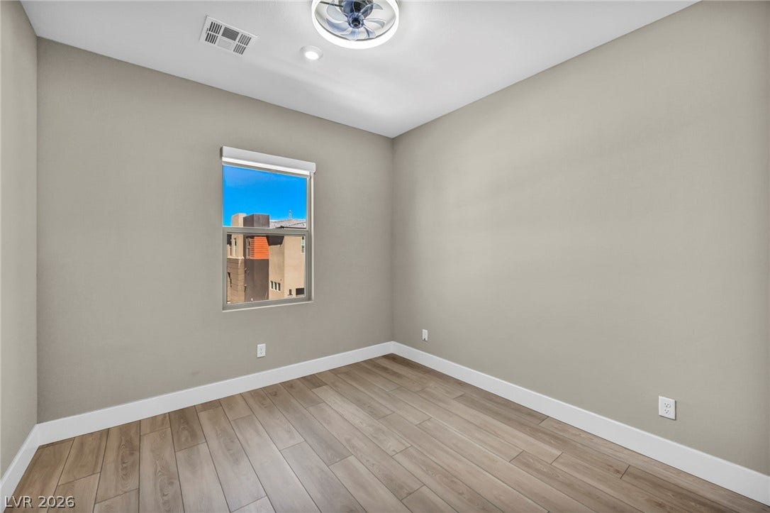 9826 Canyon Sage Street, Las Vegas, NV 89141 Smooth wood-look flooring and clean neutral walls define this versatile space.