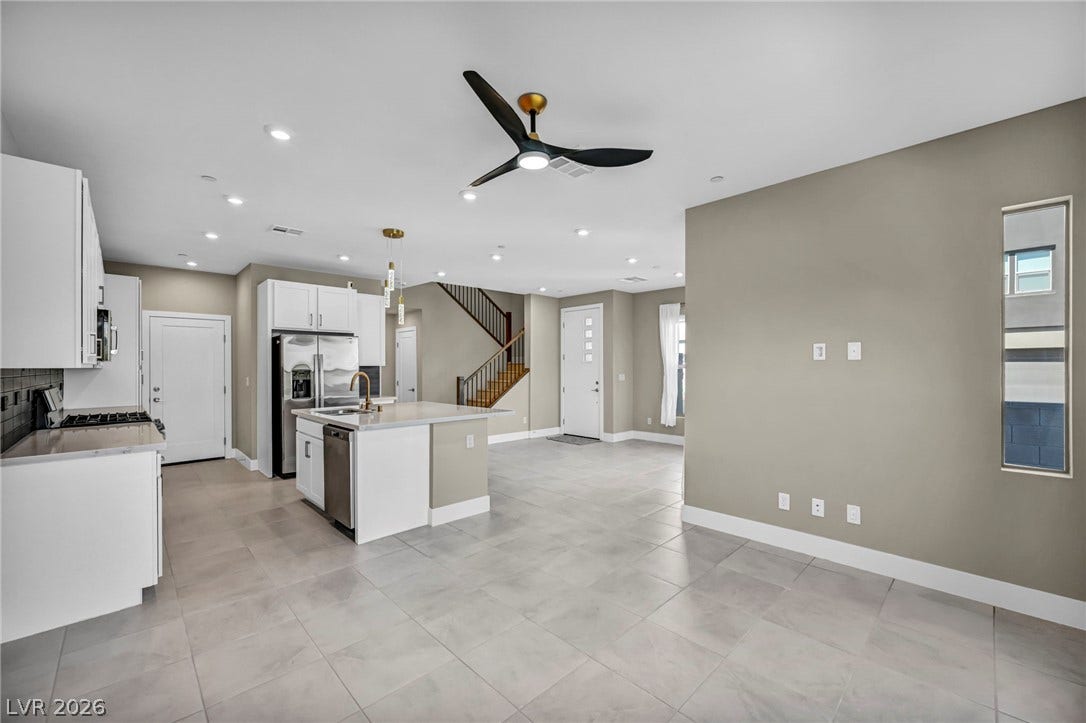 9826 Canyon Sage Street, Las Vegas, NV 89141 Gleaming tile floors stretch across a light-filled open layout connecting the kitchen and living areas.