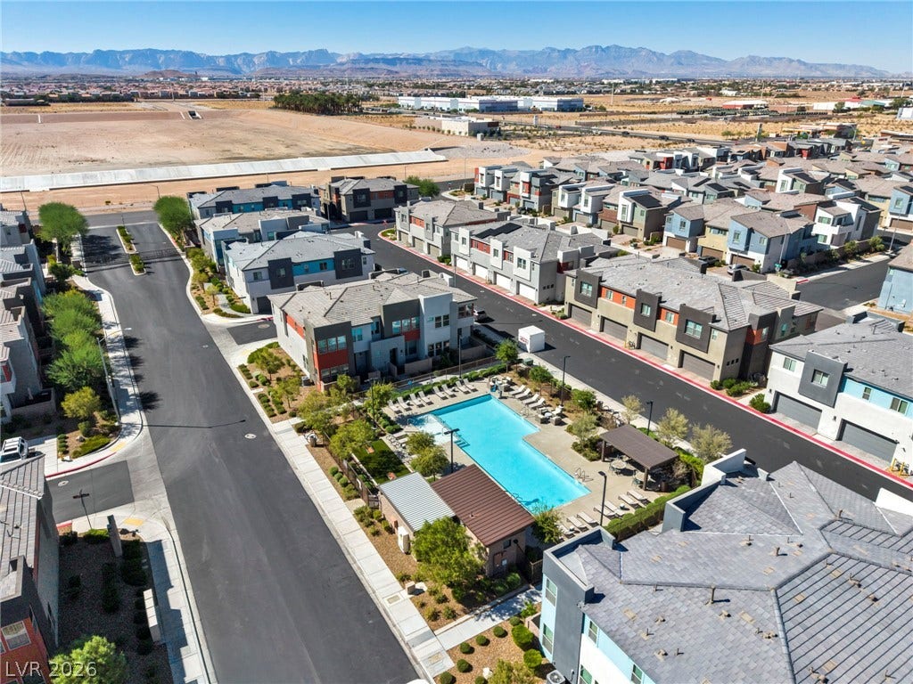 9826 Canyon Sage Street, Las Vegas, NV 89141 Distant mountains frame this modern community featuring a sparkling pool in the center.
