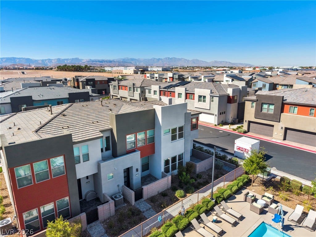 9826 Canyon Sage Street, Las Vegas, NV 89141 Distant mountains frame this modern residential community featuring sleek architecture and a sparkling neighborhood pool.