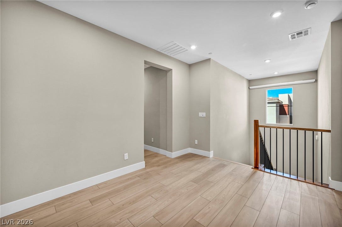 9826 Canyon Sage Street, Las Vegas, NV 89141 Clean architectural lines define this versatile upper-level landing with smooth wood floors.