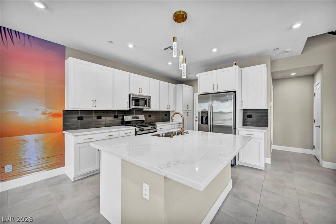 9826 Canyon Sage Street, Las Vegas, NV 89141 Streamlined cabinetry and stone countertops anchor this modern culinary workspace.
