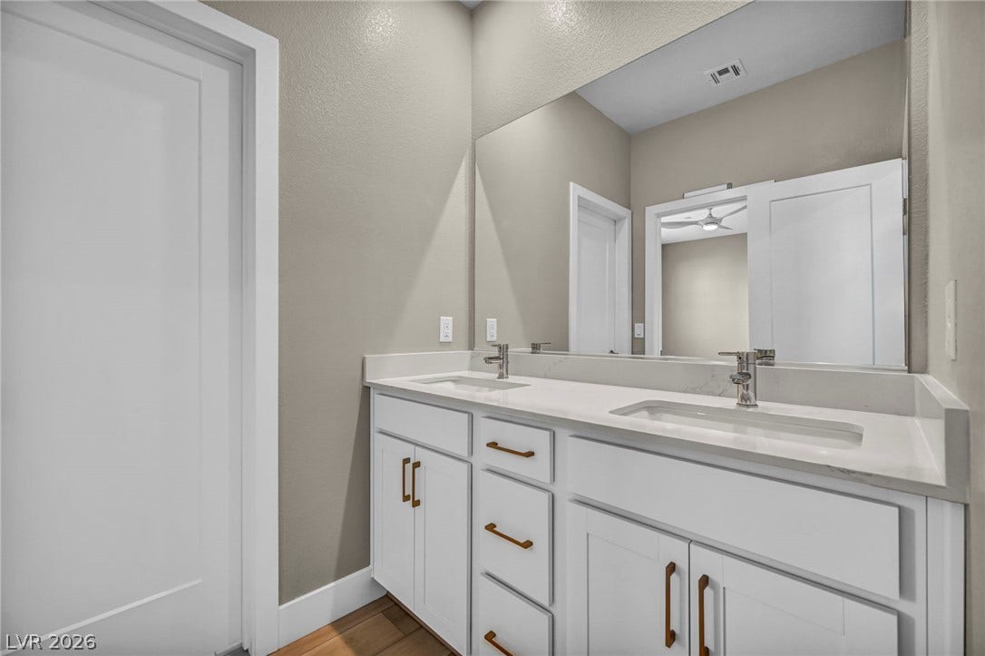 9826 Canyon Sage Street, Las Vegas, NV 89141 An elegant double vanity offers modern convenience alongside contemporary finishes.