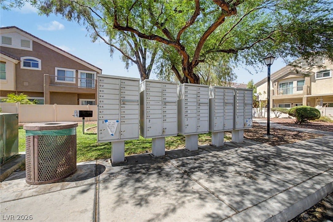 6041 Turning Spoke Trail, #102, Henderson, NV 89011 Mature trees shade the sidewalk lining this residential neighborhood community.