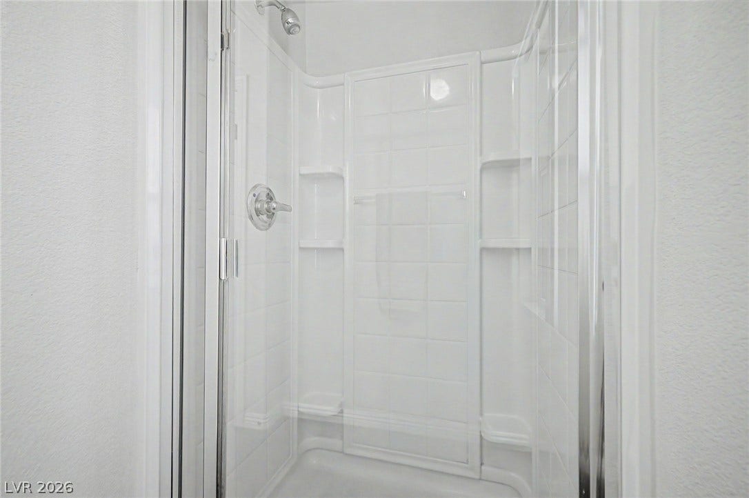 6041 Turning Spoke Trail, #102, Henderson, NV 89011 Clean lines and a modern glass enclosure define this pristine walk-in shower.