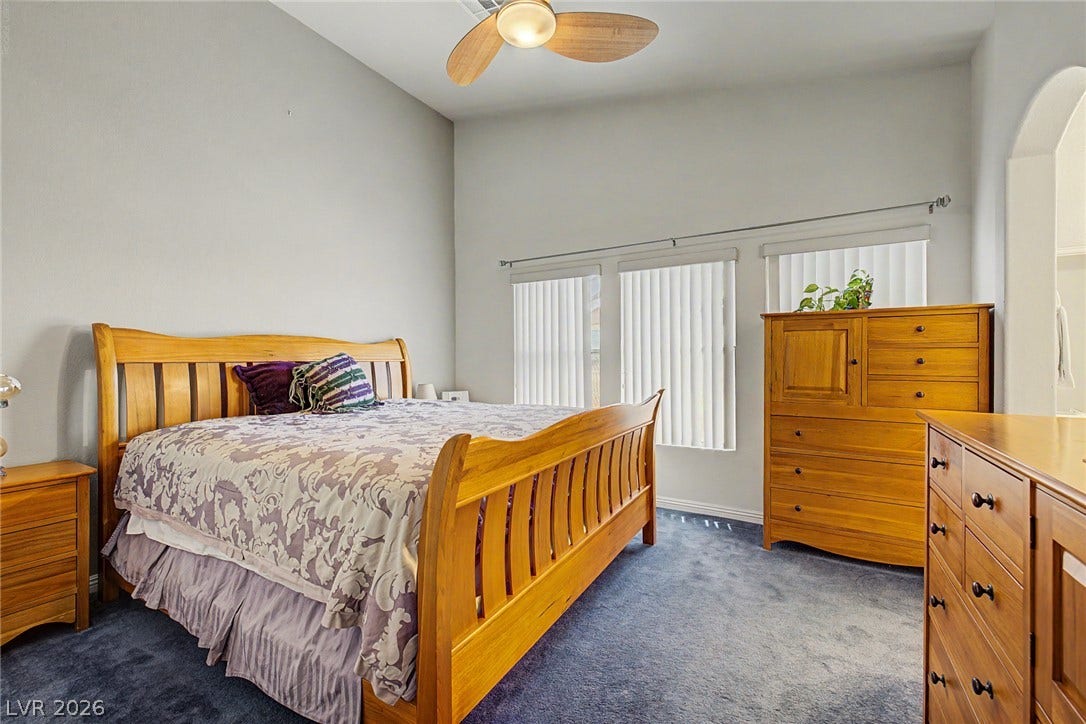 6041 Turning Spoke Trail, #102, Henderson, NV 89011 Arched doorways and tall windows highlight this peaceful bedroom space.