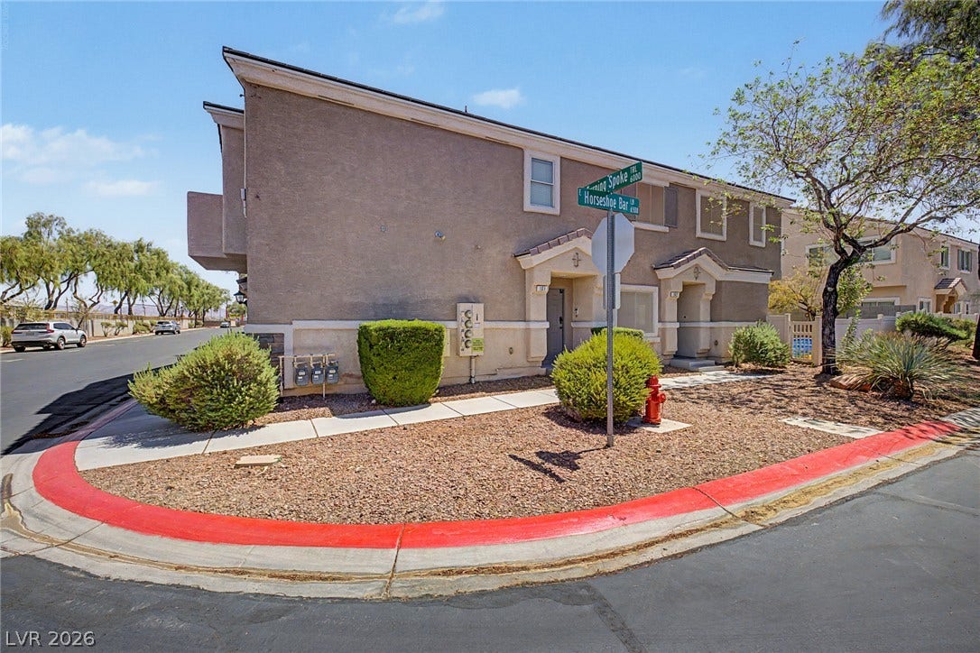 6041 Turning Spoke Trail, #102, Henderson, NV 89011 A modern exterior features neat stucco finishes and low-maintenance desert landscaping on a corner lot.