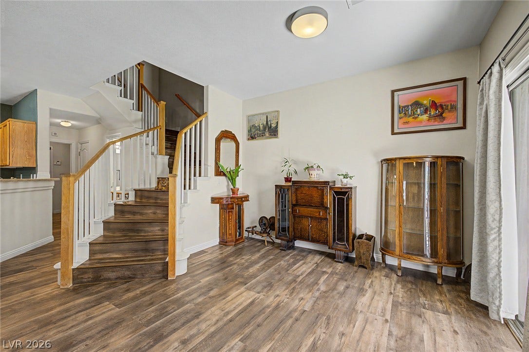 6041 Turning Spoke Trail, #102, Henderson, NV 89011 Gleaming hardwood floors and a classic staircase define this versatile entry space.