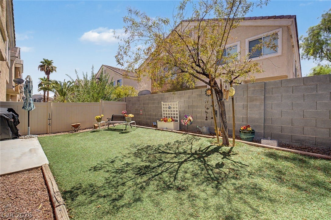 6041 Turning Spoke Trail, #102, Henderson, NV 89011 An enclosed backyard features block walls and concrete patio space.