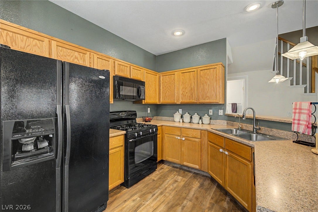 6041 Turning Spoke Trail, #102, Henderson, NV 89011 Warm oak cabinetry pairs with durable laminate countertops in this functional cooking space.