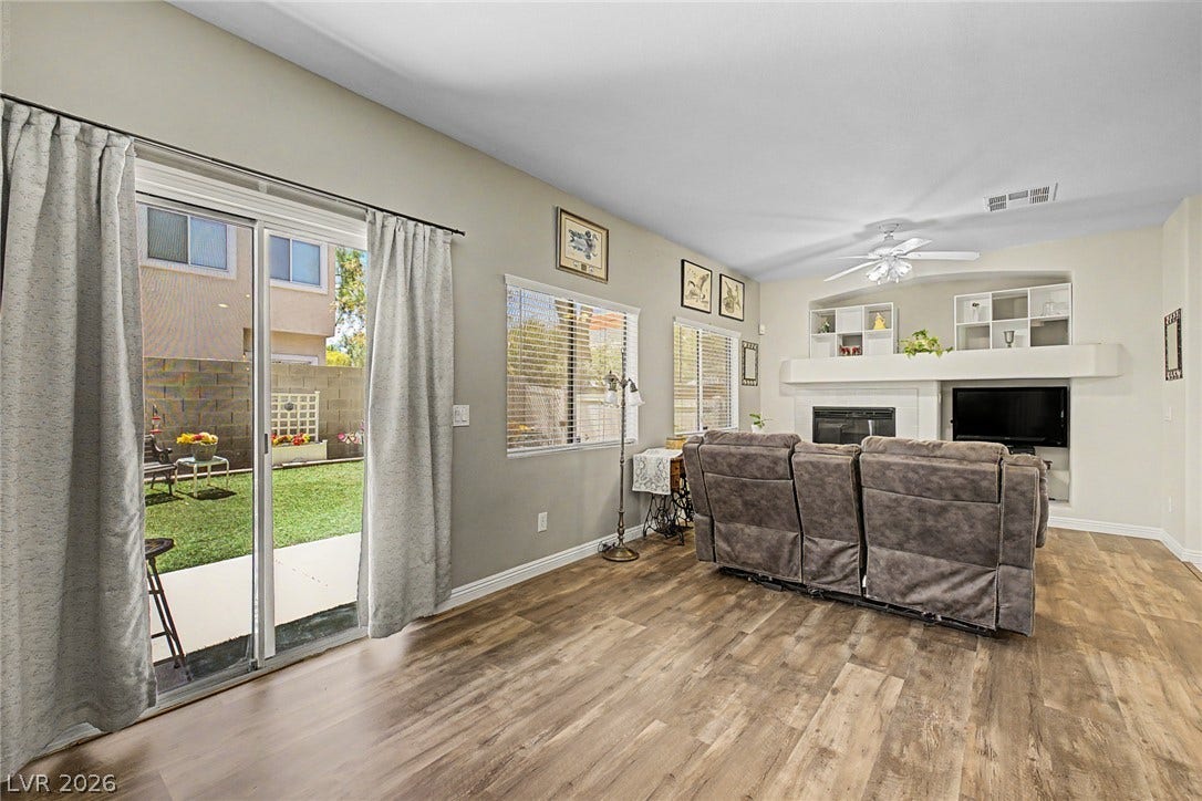 6041 Turning Spoke Trail, #102, Henderson, NV 89011 Sliding glass doors open to the yard, seamlessly blending indoor living with outdoor spaces.