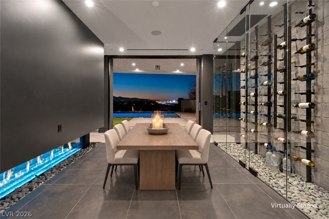 25 Boulderback Drive, Henderson, NV 89012 Gleaming tile floors and a glass-enclosed wine wall define this modern indoor-outdoor dining space.