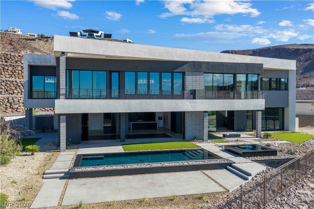 25 Boulderback Drive, Henderson, NV 89012 Clean lines and multi-level balconies overlook a private pool on this hillside desert estate.