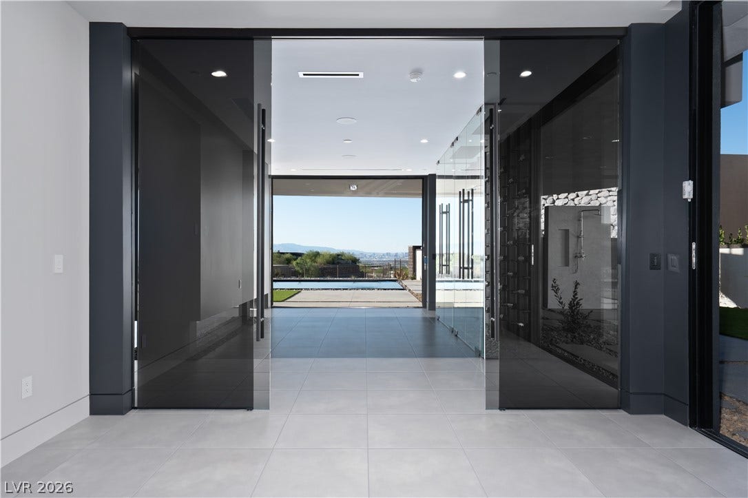 25 Boulderback Drive, Henderson, NV 89012 Clean lines and tiled floors frame a direct view toward the outdoor pool.