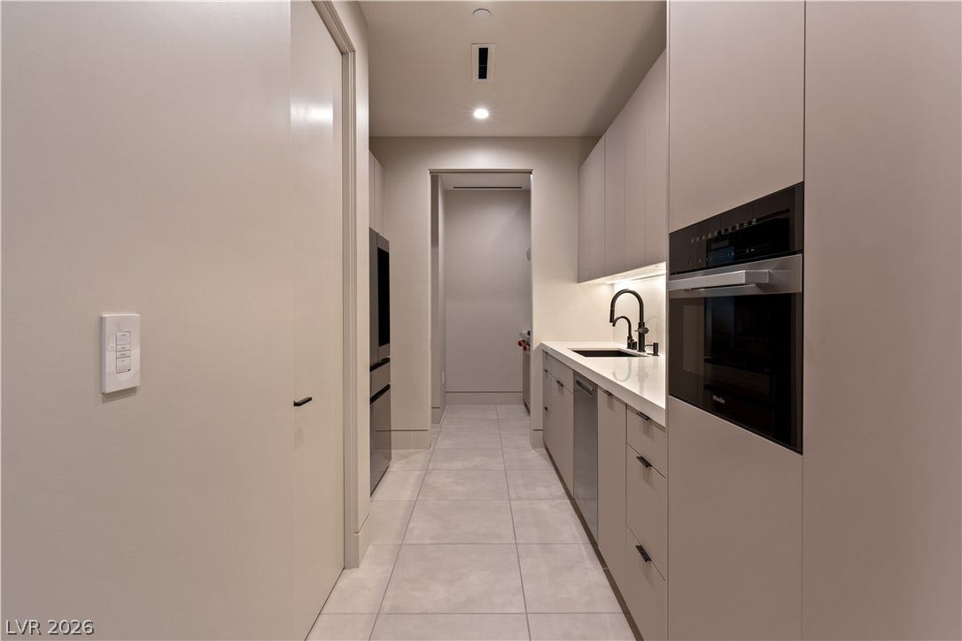 25 Boulderback Drive, Henderson, NV 89012 Minimalist cabinetry and sleek integrated appliances define this modern kitchen prep area.