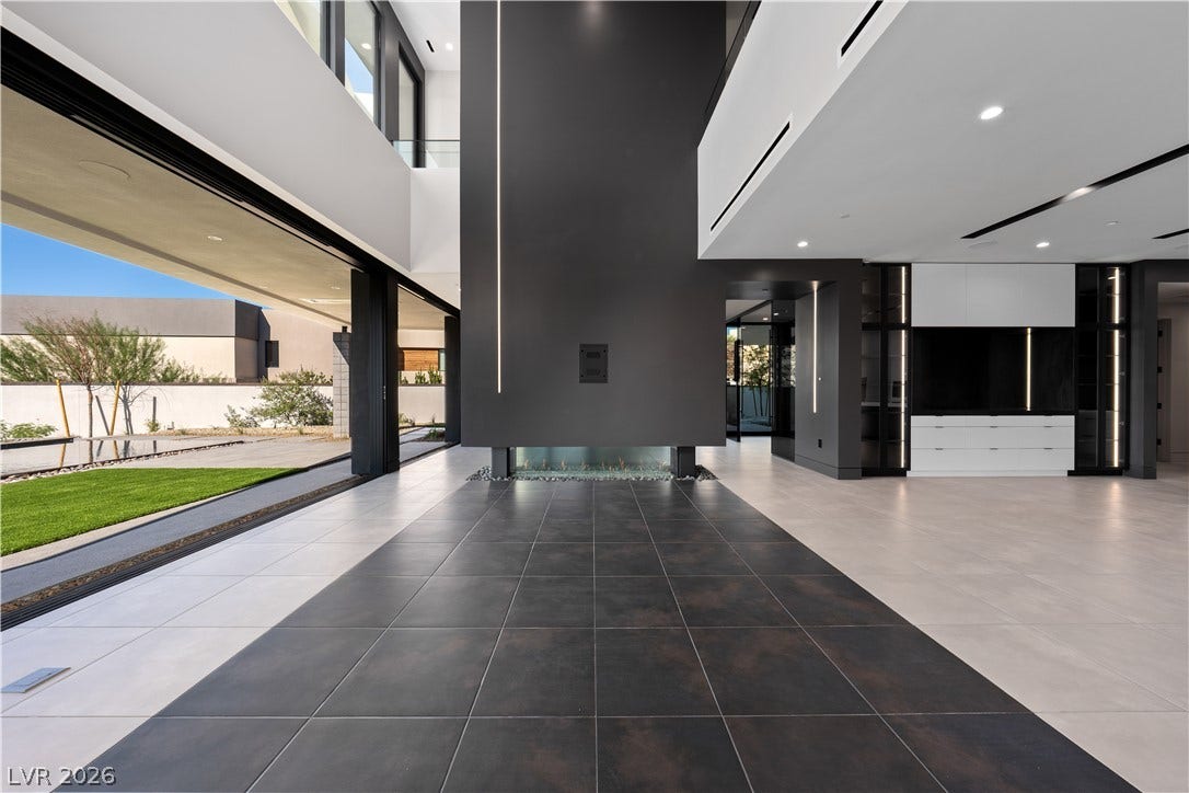 25 Boulderback Drive, Henderson, NV 89012 Dramatic modern architecture features clean lines, sleek tile flooring, and a soaring double-height ceiling.