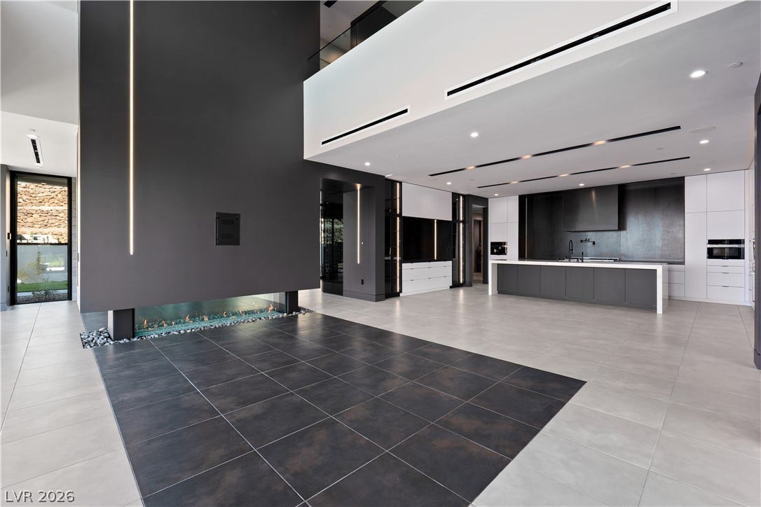 25 Boulderback Drive, Henderson, NV 89012 Dramatic modern architecture defines this open space, anchored by a sleek two-sided fireplace and minimalist kitchen.