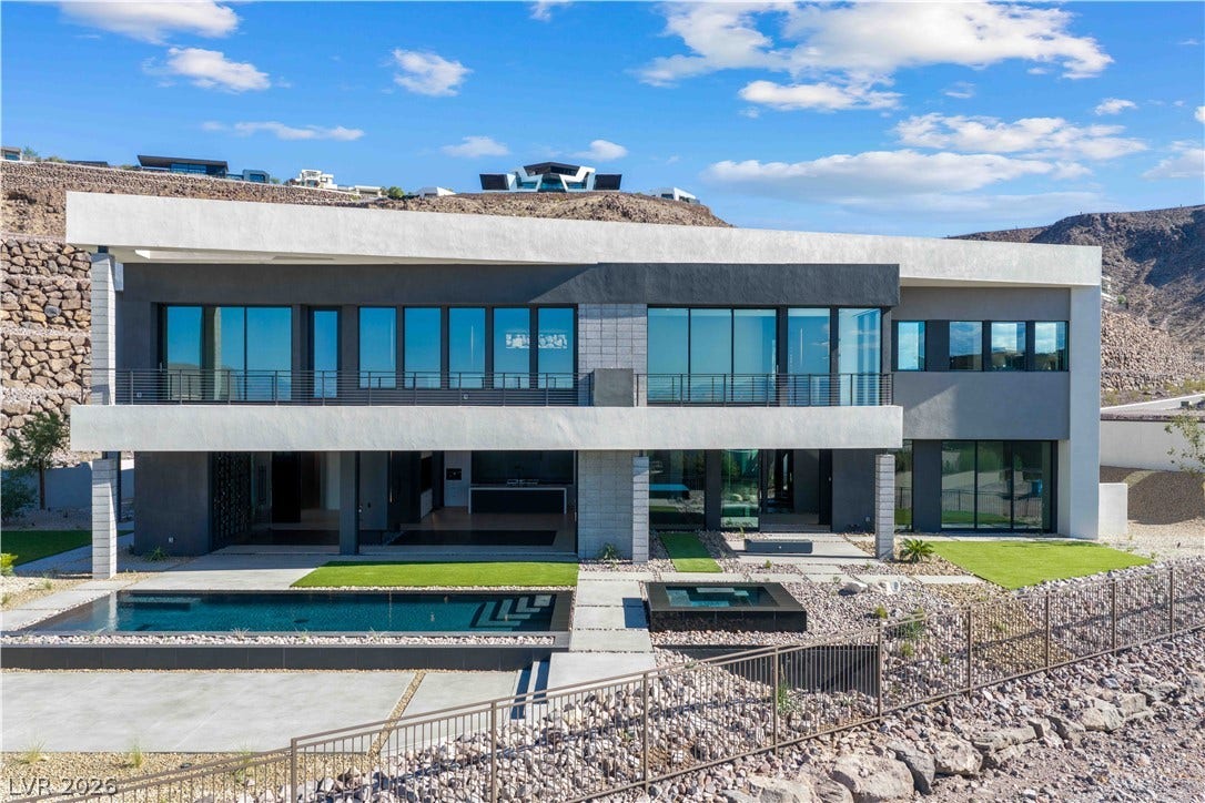 25 Boulderback Drive, Henderson, NV 89012 Sleek contemporary architecture anchors this multi-level desert estate featuring an integrated pool and spa.