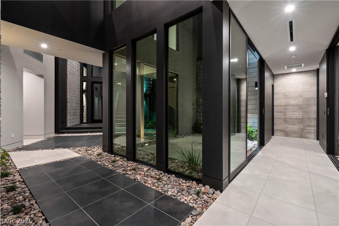 25 Boulderback Drive, Henderson, NV 89012 Bold architectural lines and massive glass walls frame a striking modern transition between spaces.