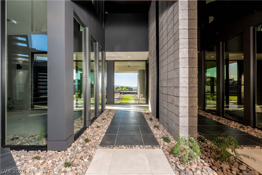 25 Boulderback Drive, Henderson, NV 89012 Dramatic modern pathways line this architectural entryway framed by towering glass and stone columns.