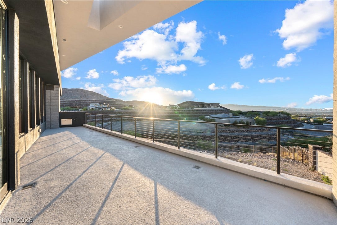 25 Boulderback Drive, Henderson, NV 89012 Panoramic mountain and valley vistas unfold from this covered concrete terrace.