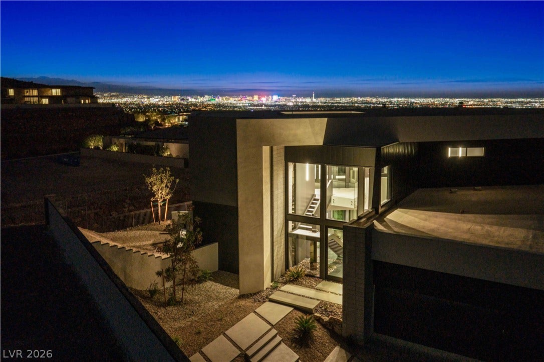 25 Boulderback Drive, Henderson, NV 89012 Dramatic modern architecture frames glittering skyline panoramas from an elevated hillside vantage.