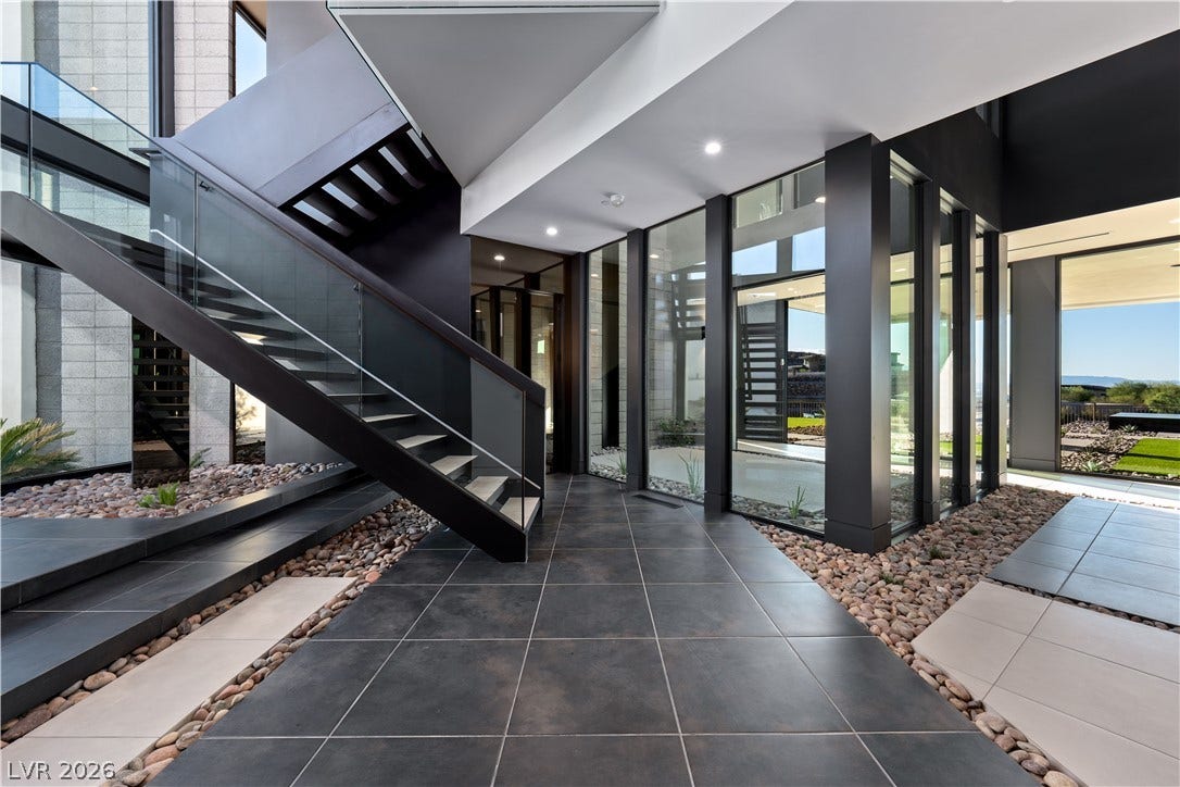 25 Boulderback Drive, Henderson, NV 89012 Dramatic architectural lines and walls of glass define this striking modern entryway.