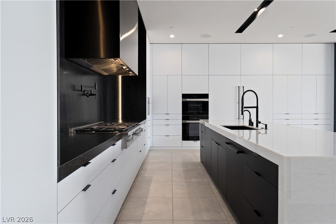25 Boulderback Drive, Henderson, NV 89012 Clean minimalist architecture defines this gourmet culinary space with seamless custom cabinetry and premium finishes.