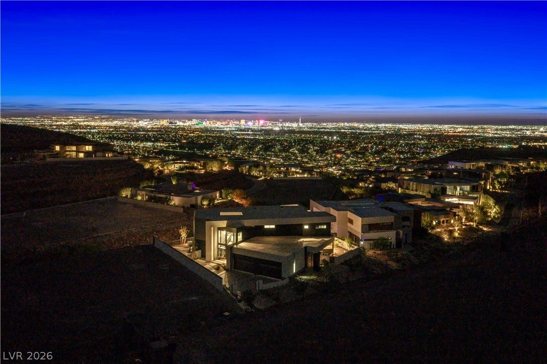 25 Boulderback Drive, Henderson, NV 89012 Glimmering city lights stretch across the horizon from this elevated hillside vantage point.
