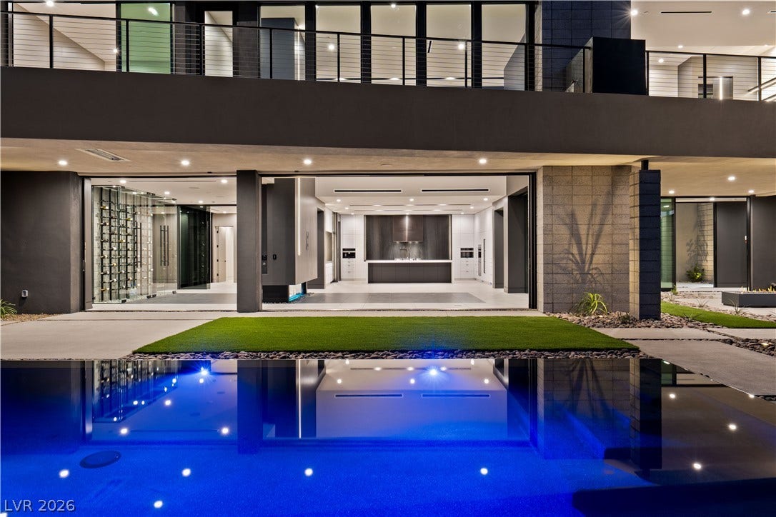 25 Boulderback Drive, Henderson, NV 89012 A sparkling pool reflects the modern multi-level architecture and open-concept living spaces beyond.