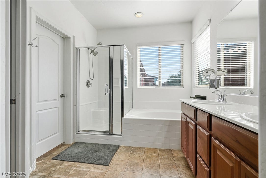 Clean lines define this well-appointed bathroom with a separate glass shower and soaking tub.