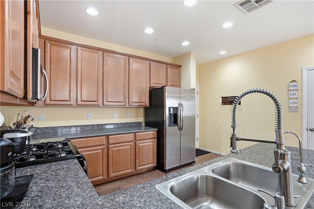 Gleaming stone countertops and classic wood cabinetry define this functional culinary space.