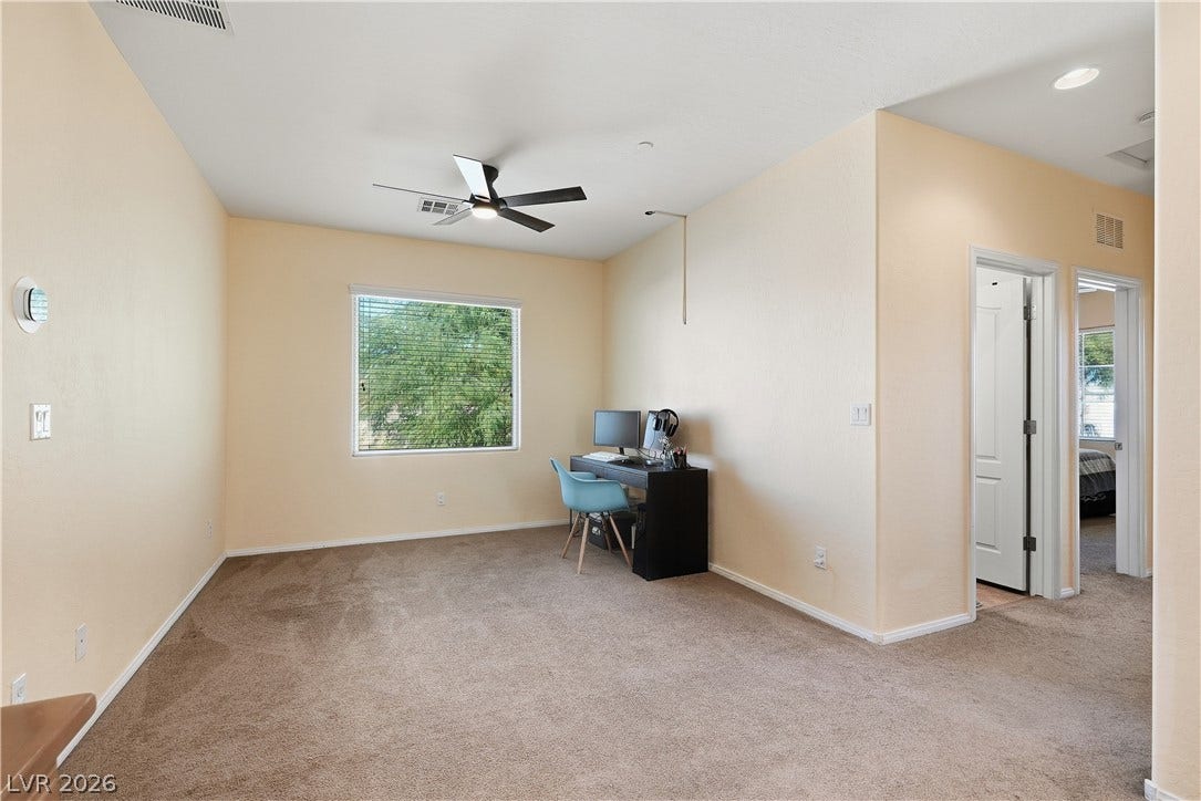 Plentiful natural light fills a versatile upper-level space featuring wall-to-wall carpeting.