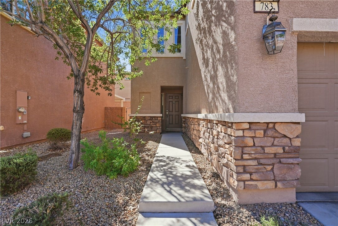 Stone accents and a paved walkway guide visitors toward the recessed main entrance.