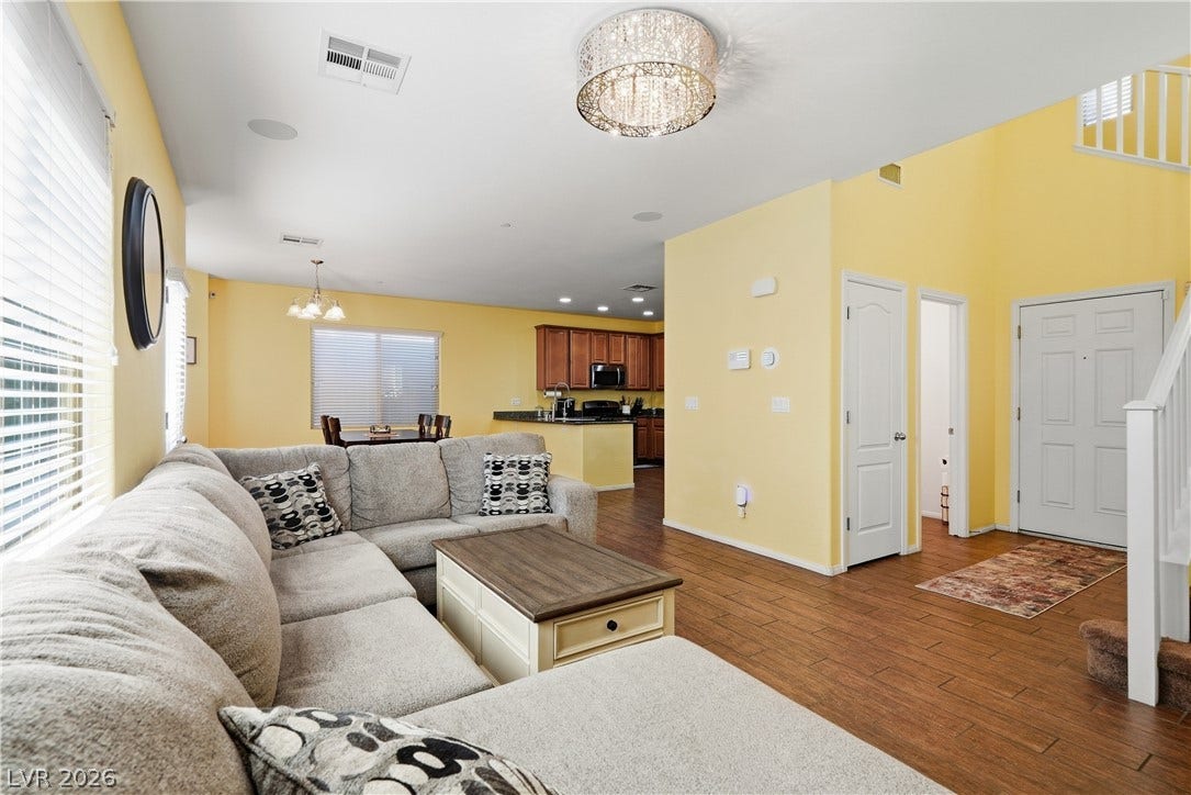 Gleaming hardwood floors and a spacious open layout connect the entryway to the kitchen.