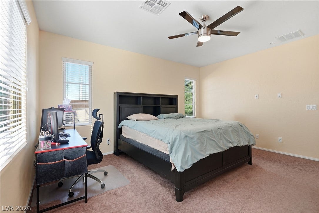 Plentiful windows fill this bedroom with natural light.